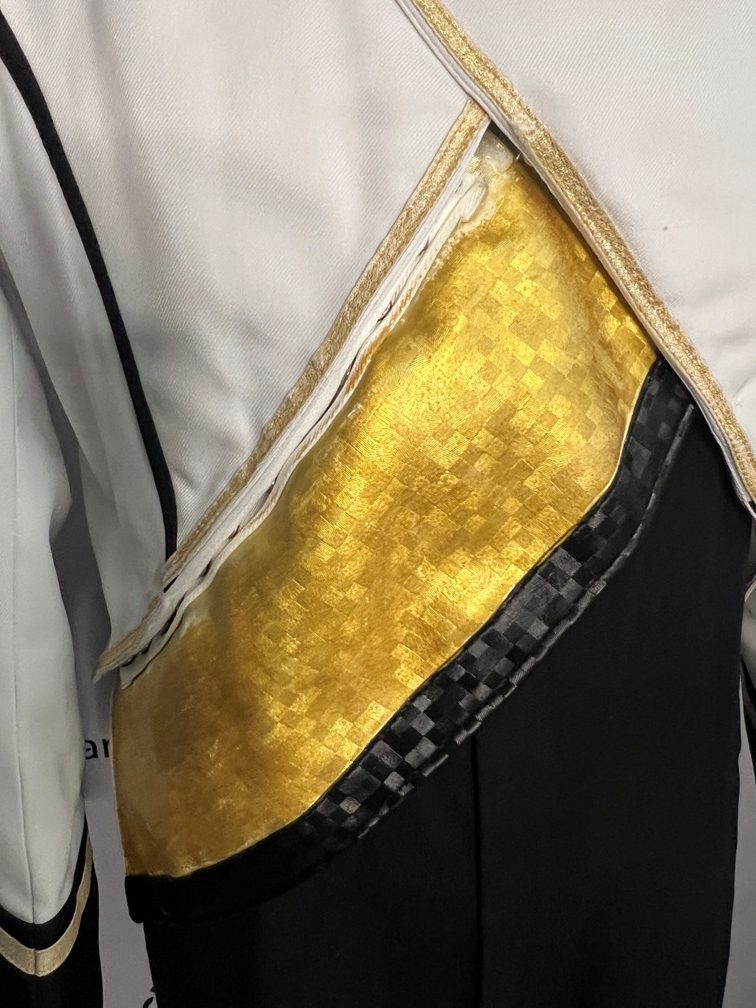 This is a lot of 170+/- black, white and gold marching band jackets.