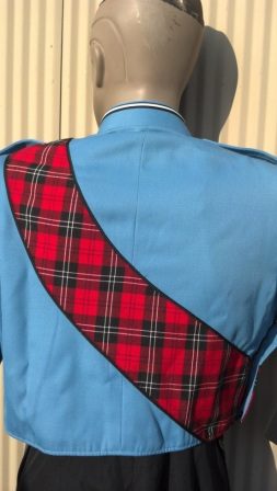 This is a columbia blue marching band jacket with black trim, a sewn-on