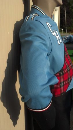 This is a columbia blue marching band jacket with black trim, a sewn-on