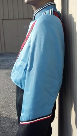 This is a columbia blue marching band jacket with black trim, a sewn-on