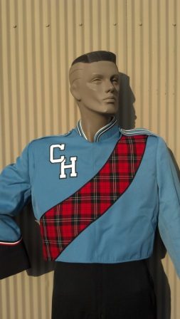 This is a columbia blue marching band jacket with black trim, a sewn-on