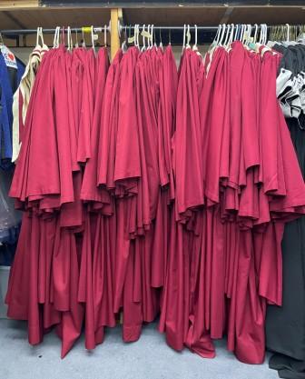 Lot of red choir robes and matching stoles